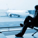 man sitting and watching airplane