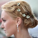 girl with golden brown hairs and flower pins side pose
